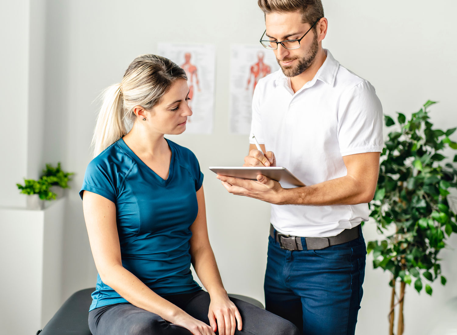 Chiropractic doctor discussing notes with a patient